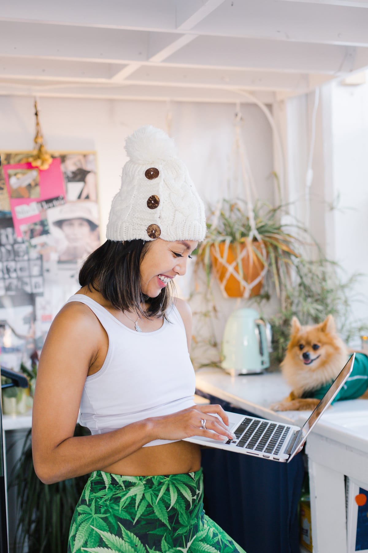Woman smiling while checking her laptop at home